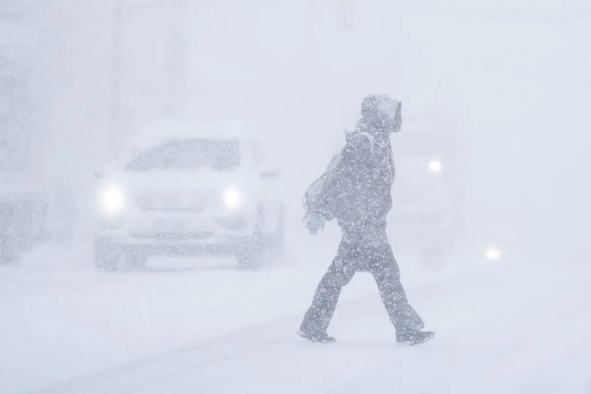 A pedestrian crosses a street in Halifax during a winter storm on Jan. 20, 2023. (The Canadian Press/Darren Calabrese)