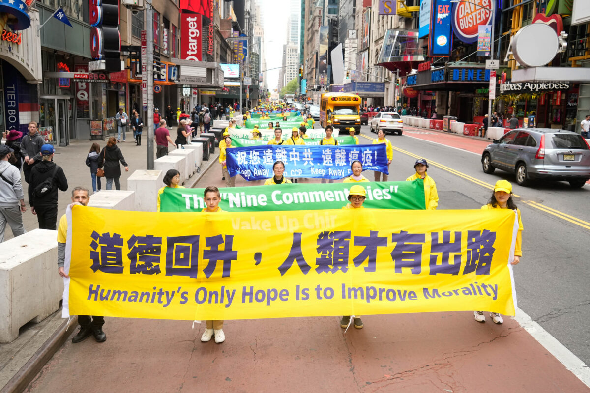 Falun Gong practitioners take part in a parade marking the 30th anniversary of the spiritual discipline's introduction to the public, in New York on May 13, 2022. (Larry Dye/The Epoch Times)