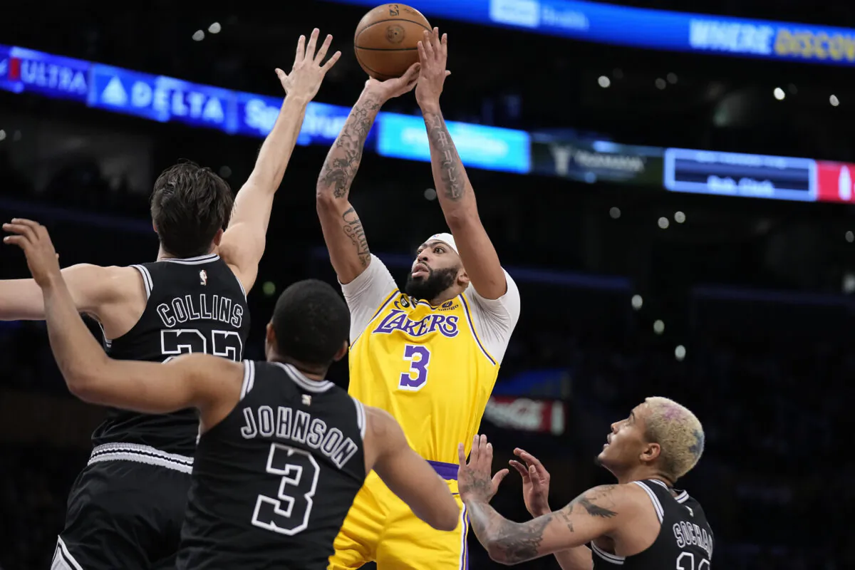 Los Angeles Lakers forward Anthony Davis, second from right, shoots as San Antonio Spurs forward Zach Collins, left, forward Keldon Johnson, second from right, and forward Jeremy Sochan defend during the first half of an NBA basketball game in Los Angeles on Jan. 25, 2023. (Mark J. Terrill/AP Photo)