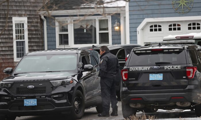 Duxbury Police work at the scene where two children were found dead and an infant injured in Duxbury, Mass., on Jan. 25, 2023. (David L Ryan/The Boston Globe via AP)