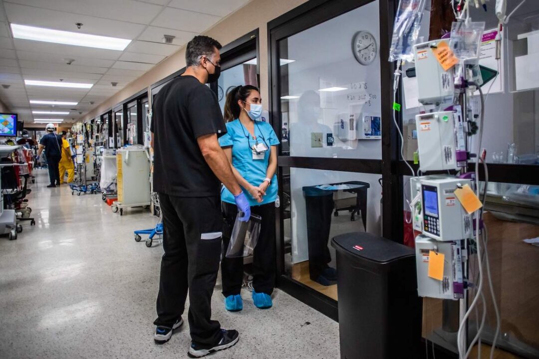 A doctor and a nurse stand in the hallway of a hospital, in this file photo. (Apu Gomes/AFP via Getty Images)
