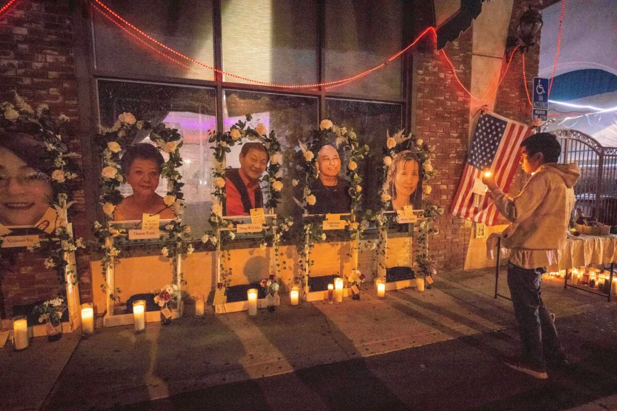 Eric Sham visits a makeshift memorial for those killed in a mass shooting at The Star Ballroom Dance Studio in Monterey Park, Calif., on Jan. 24, 2023. (Sarah Reingewirtz/The Orange County Register via AP)