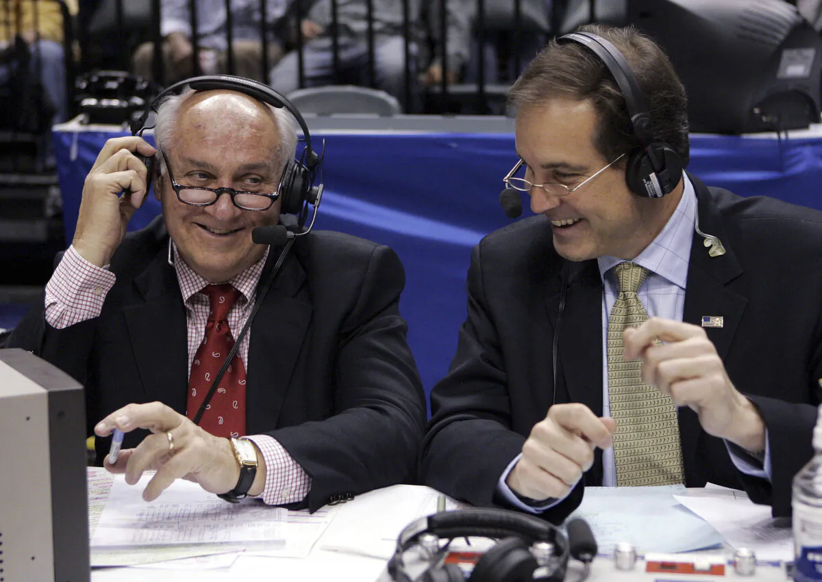 CBS announcers Billy Packer (L) and Jim Nantz laugh during a break in the championship game in the Big Ten basketball tournament in Indianapolis on March 12, 2006. (Michael Conroy/AP Photo)