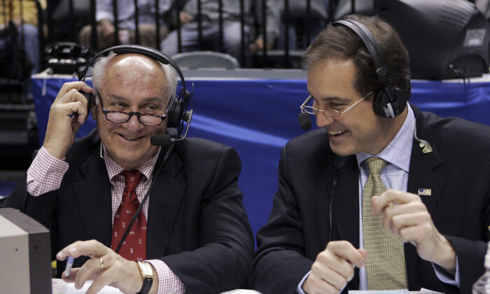 CBS announcers Billy Packer (L) and Jim Nantz laugh during a break in the championship game in the Big Ten basketball tournament in Indianapolis on March 12, 2006. (Michael Conroy/AP Photo)