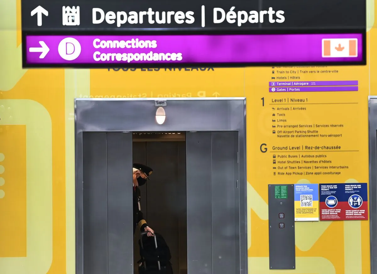 A pilot takes the elevator at Toronto Pearson International Airport in Toronto on Dec. 14, 2020.(The Canadian Press/Nathan Denette)