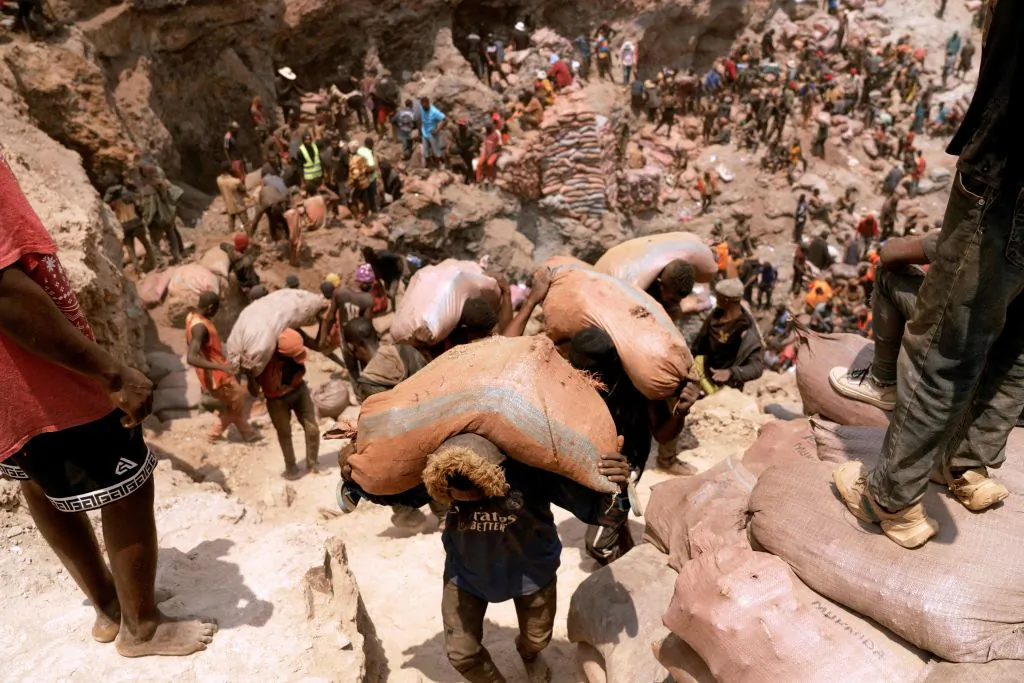 Artisanal miners carry sacks of ore at the Shabara artisanal cobalt mine near Kolwezi in the Democratic Republic of the Congo on Oct. 12, 2022. (Junior Kannah/AFP via Getty Images)
