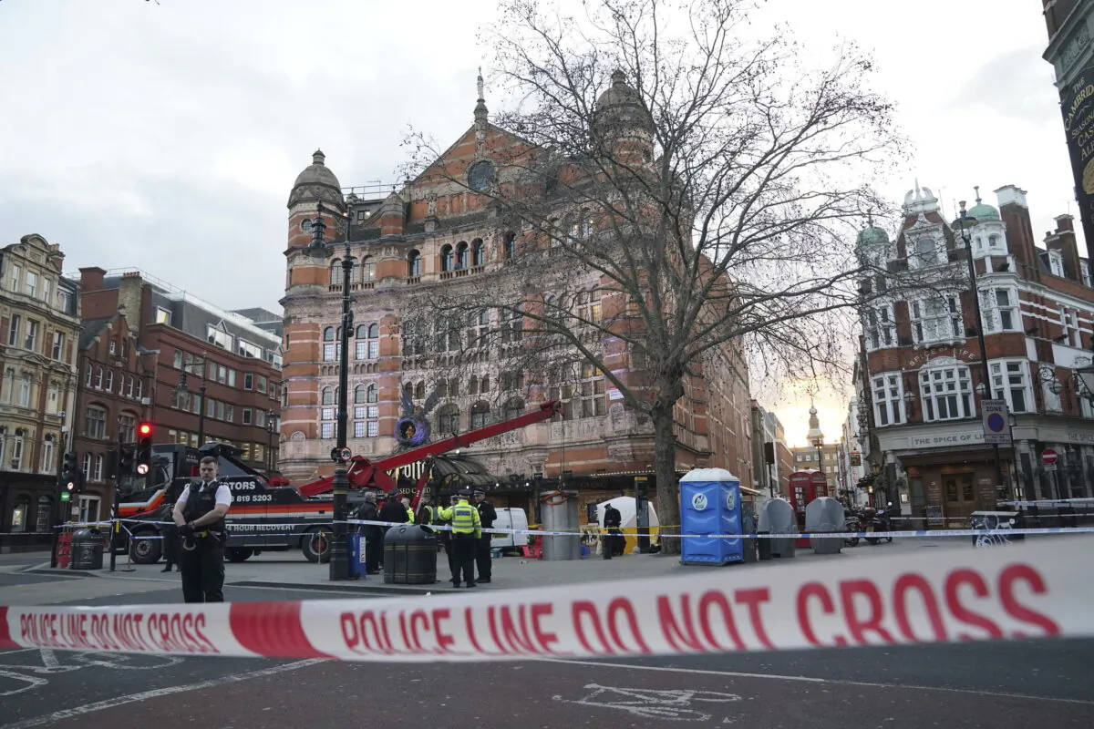 A police tent is erected at Cambridge Circus on the junction between Shaftesbury Avenue and Charing Cross Road in London on Jan. 27, 2023. (Jonathan Brady/PA via AP)