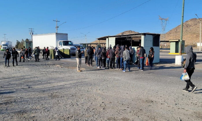 Guatemalan unaccompanied minors who were traveling in a crowded truck are seen with Mexican authorities after being spotted at a checkpoint in Ciudad Juarez, Mexico, in this handout picture distributed to Reuters on Jan. 26, 2023. (Mexico's National Institute of Migration (INM)/Handout via Reuters)