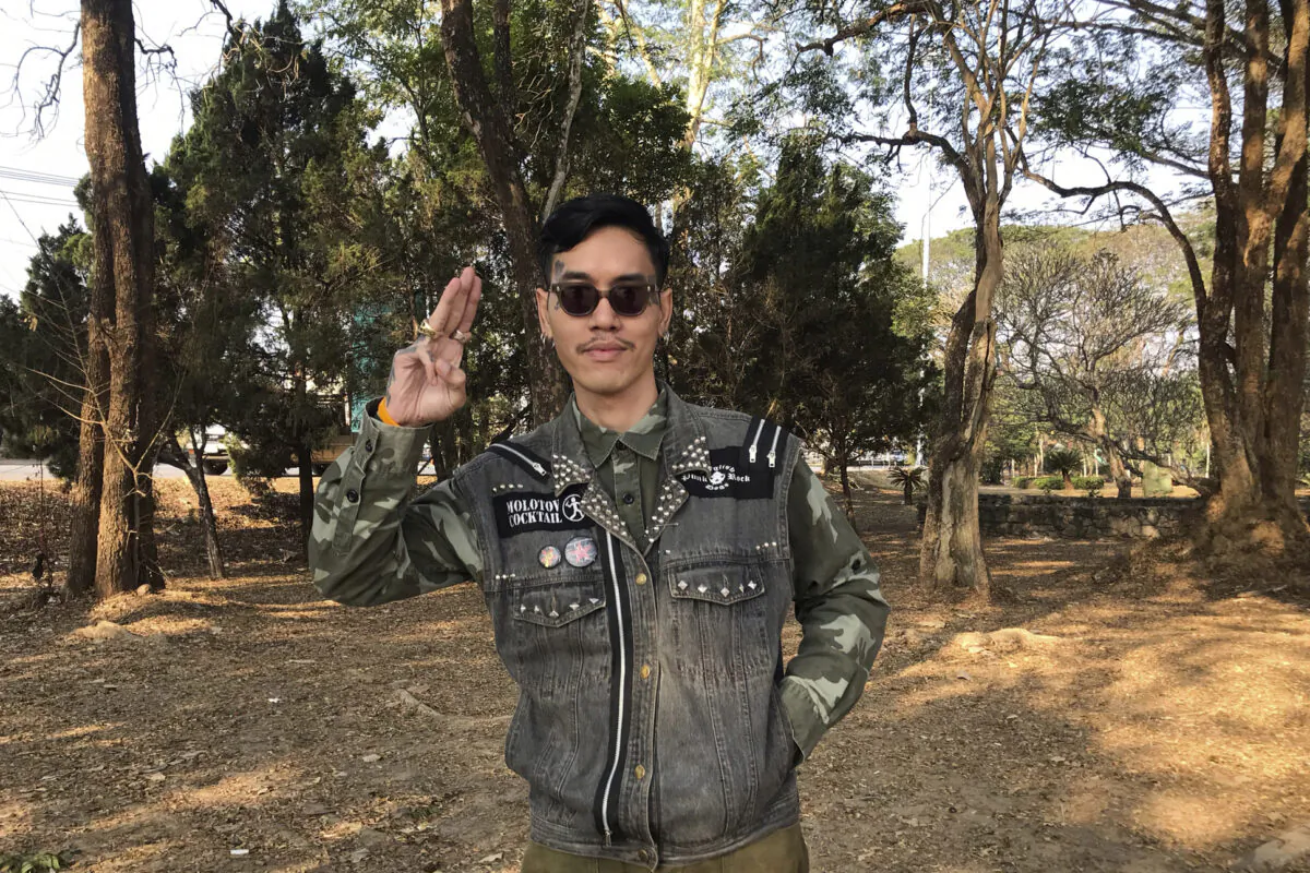 Political activist Mongkhon Thirakot flashes the pro-democracy gesture of a three-finger salute ahead of going to a court in Thailand's northern province of Chiang Rai, Thailand, on Jan. 26, 2023. (Thai Lawyers for Human Rights via AP)