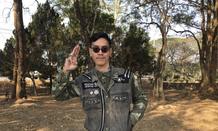 Political activist Mongkhon Thirakot flashes the pro-democracy gesture of a three-finger salute ahead of going to a court in Thailand's northern province of Chiang Rai, Thailand, on Jan. 26, 2023. (Thai Lawyers for Human Rights via AP)