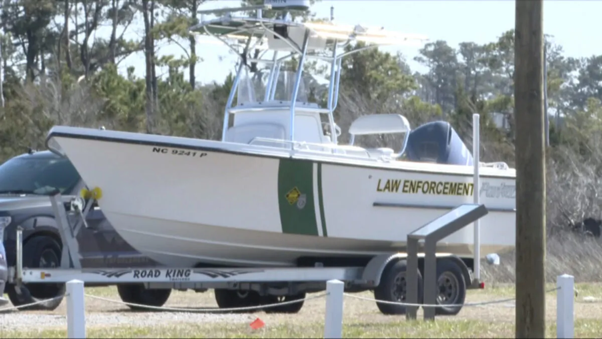 Law enforcement get ready for a search after a small plane crash in Carteret County, N.C., on Feb. 14, 2022. (WCTI-TV via AP)