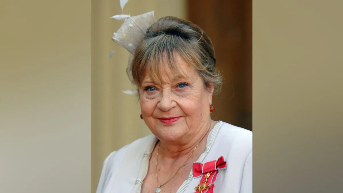 Sylvia Syms looks on at Buckingham after collecting her OBE from Queen Elizabeth II in London on Oct. 18, 2007. (Fiona Hanson/PA via AP)