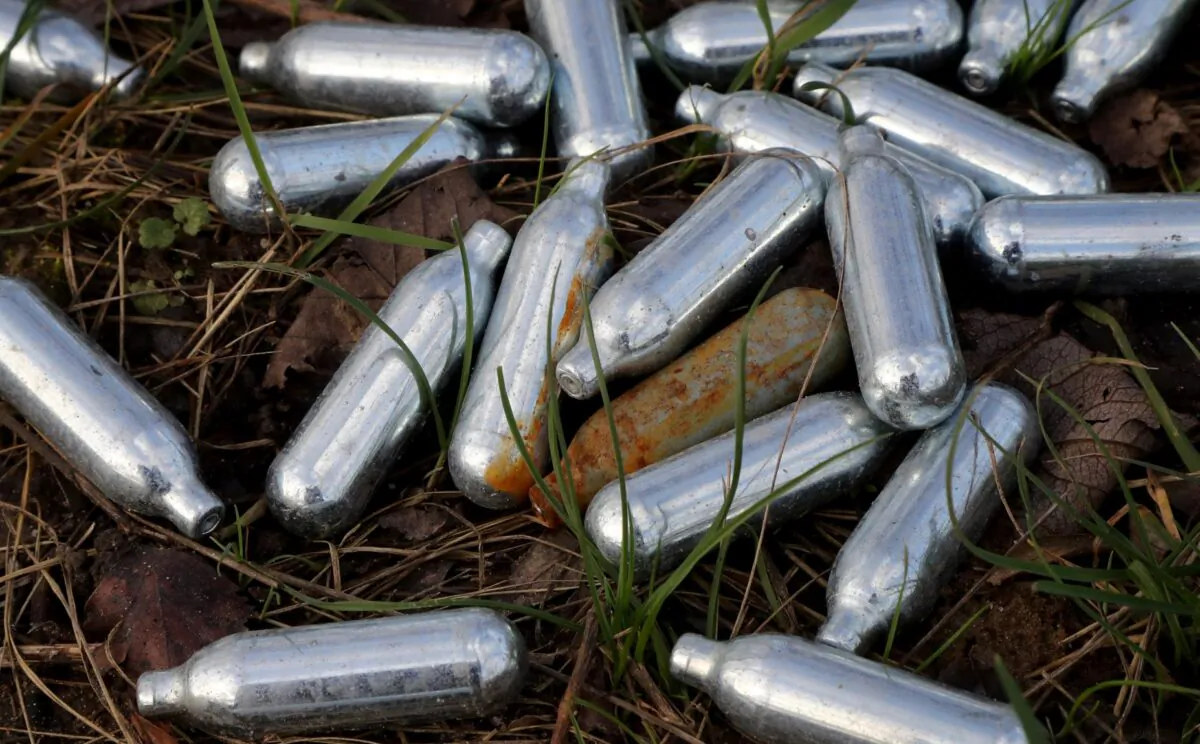 Nitrous oxide canisters discarded by the roadside in Ebbsfleet, England, in January 2020. (PA)