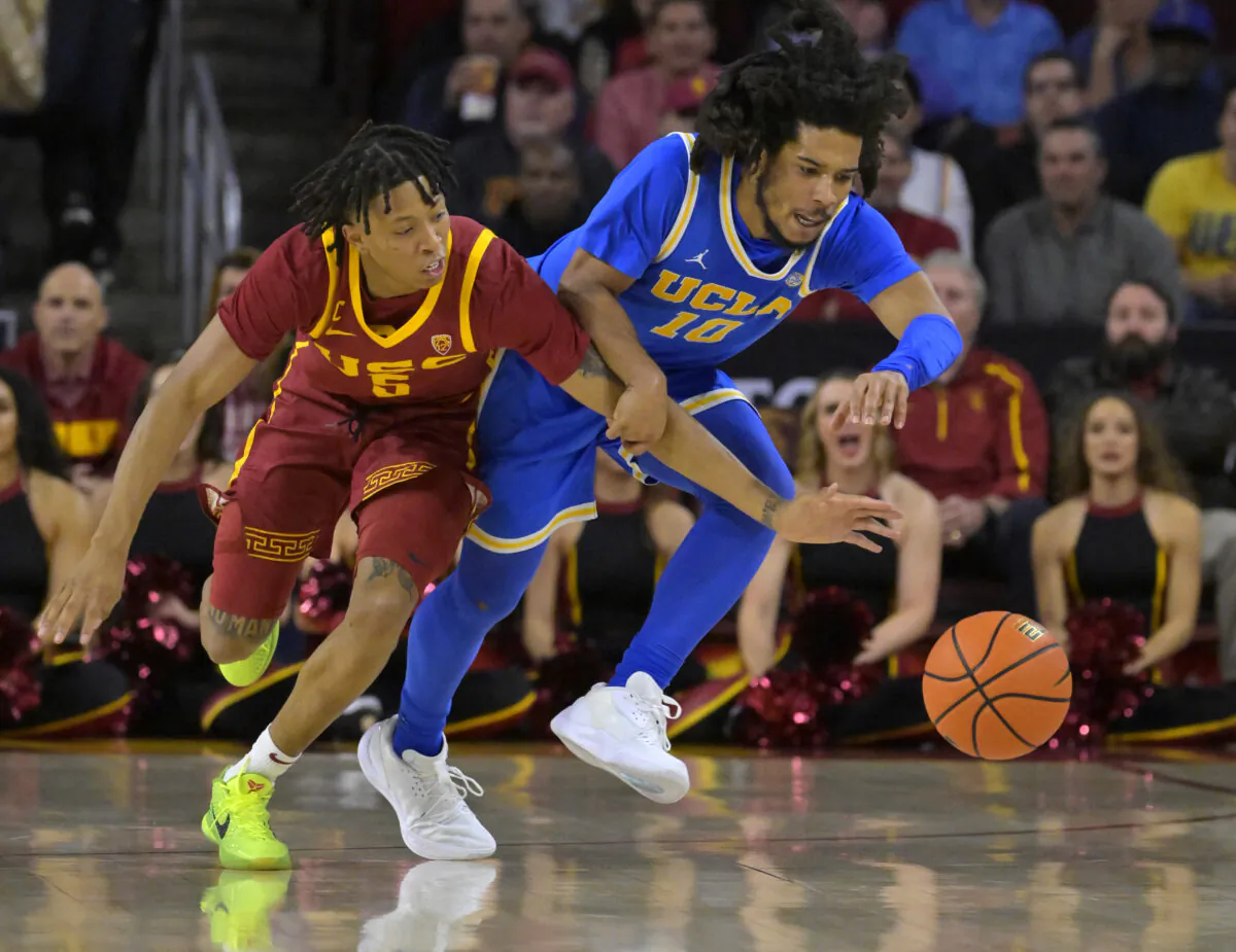 Boogie Ellis (5) of the USC Trojans and Tyger Campbell (10) of the UCLA Bruins chase down a loose ball in the first half at Galen Center on Jan. 26, 2023. (Jayne Kamin-Oncea/Getty Images)