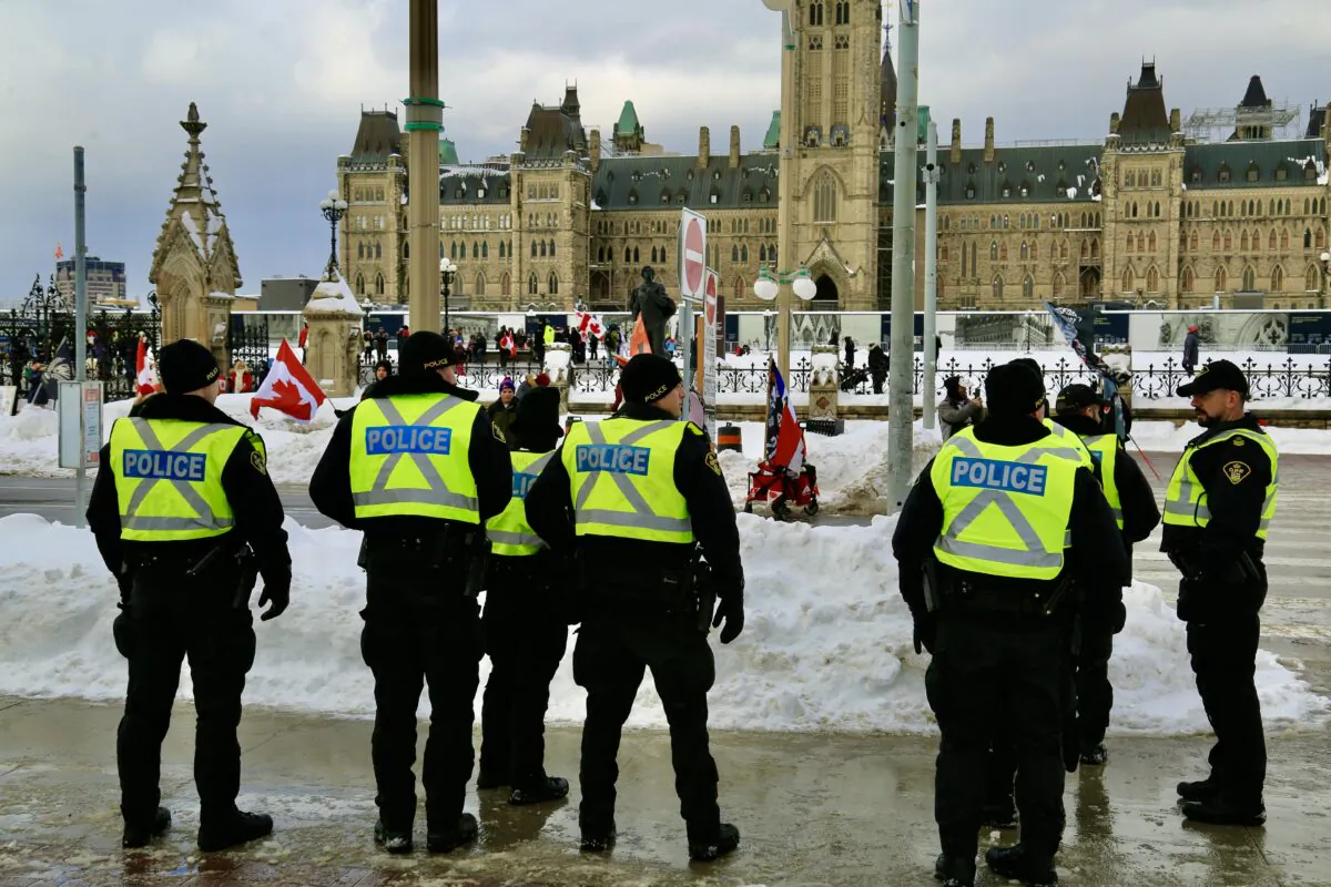 Ottawa police monitor the celebration of the Freedom Convoy's first anniversary, on Parliament Hill on Jan. 28, 2023. (Jonathan Ren/The Epoch Times)