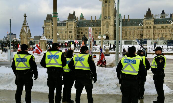 Ottawa police monitor the celebration of the Freedom Convoy's first anniversary, on Parliament Hill on Jan. 28, 2023. (Jonathan Ren/The Epoch Times)