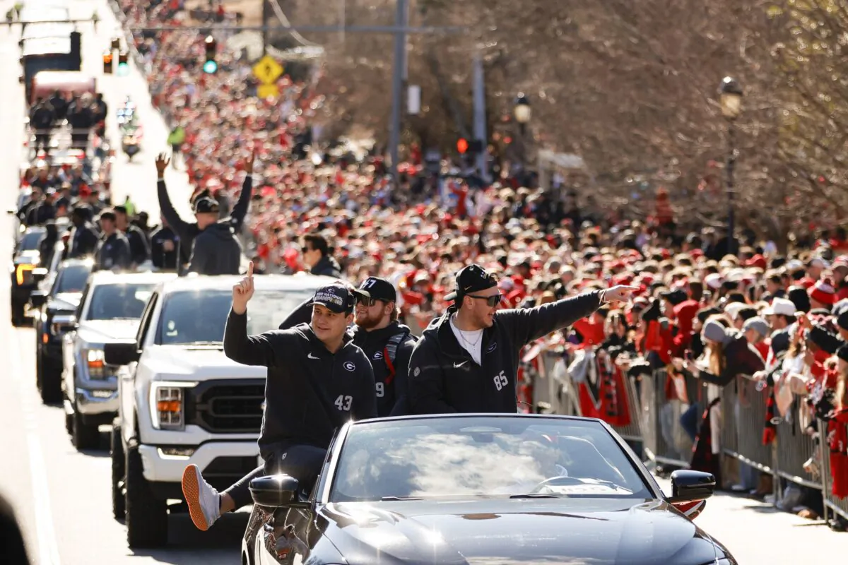 Georgia football players acknowledge the crowd during a parade celebrating the Bulldog's second consecutive NCAA college football national championship,  in Athens on Jan. 14, 2023. (Alex Slitz/AP Photo)