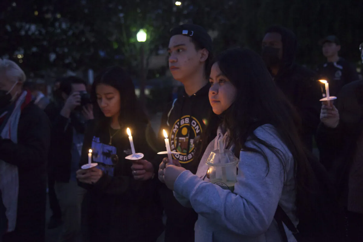People hold candles at the vigil in Portsmouth Square in San Francisco on Jan. 26, 2023. (Lear Zhou/The Epoch Times)