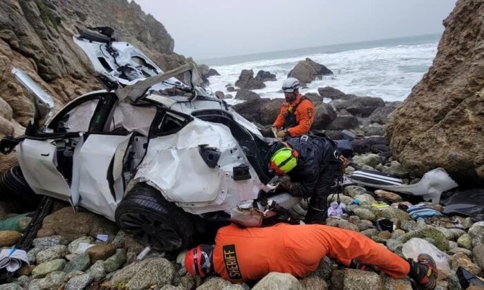 Emergency personnel respond to a vehicle over the side of Highway 1, in San Mateo County, Calif., on Jan. 1, 2023. (Sgt. Brian Moore/San Mateo County Sheriff's Office via AP)