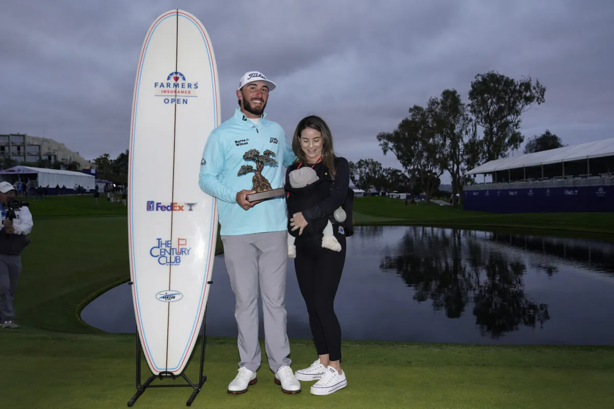 Max Homa holds the trophy as he stands alongside his wife, Lacey, and baby Cameron, after winning the Farmers Insurance Open golf tournament  in San Diego on Jan. 28, 2023. (Gregory Bull/AP Photo)