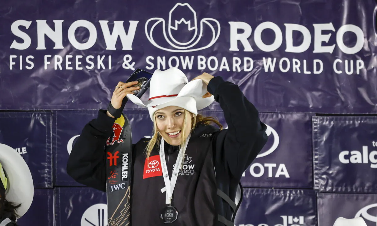 Eileen Gu of China celebrates on the podium after her victory in the women's World Cup freestyle ski halfpipe event in Calgary, Alberta, on Jan. 21, 2023. (Jeff McIntosh/The Canadian Press via AP)
