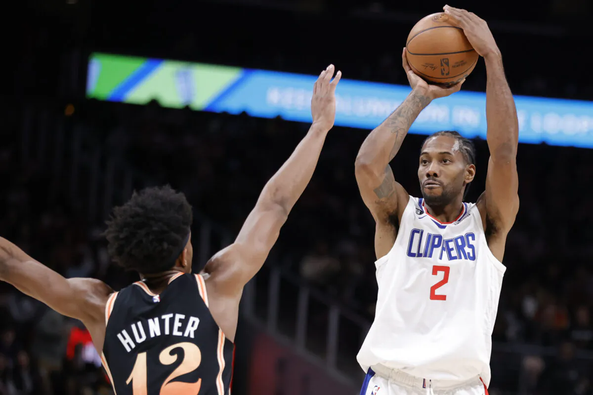 Kawhi Leonard (2) of the LA Clippers takes a shot over De'Andre Hunter (12) of the Atlanta Hawks during the second half at State Farm Arena in Atlanta on Jan. 28, 2023. (Alex Slitz/Getty Images)
