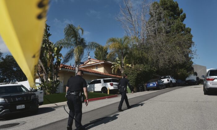 Police block the street to a house where three people were killed and four others wounded in a shooing at a short-term rental home in an upscale Los Angeles neighborhood on Jan. 28, 2023. (Richard Vogel/AP Photo)