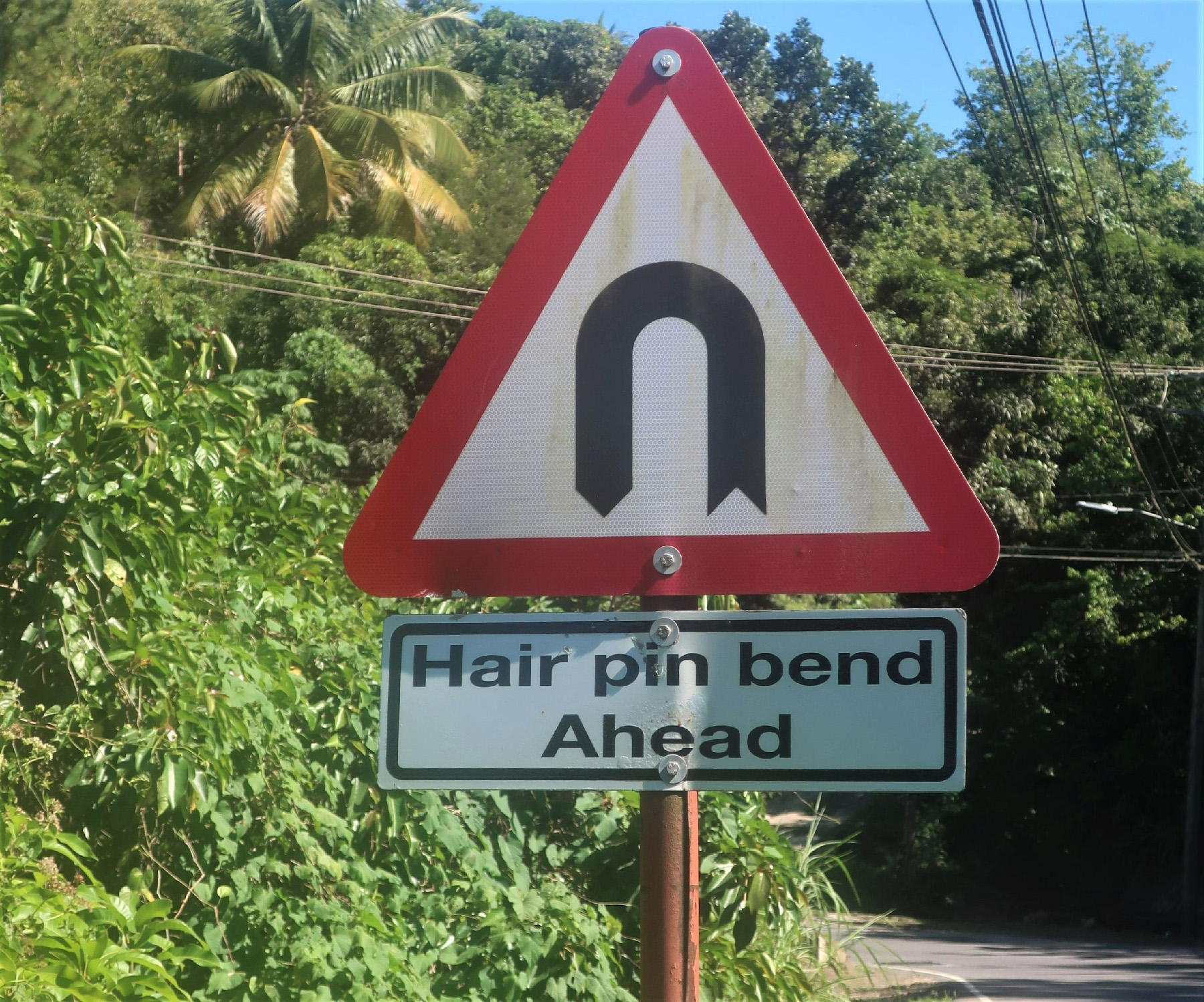 Signs warning of hairpin turns are frequent on roads in St. Lucia.