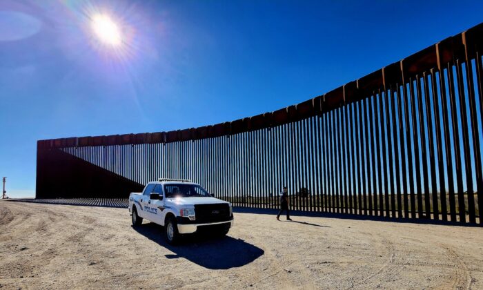 Police Lt. Marco Santana leaves his vehicle to inspect a section of the southern border wall in San Luis, Ariz., on Jan. 27, 2023. (Allan Stein/The Epoch Times)