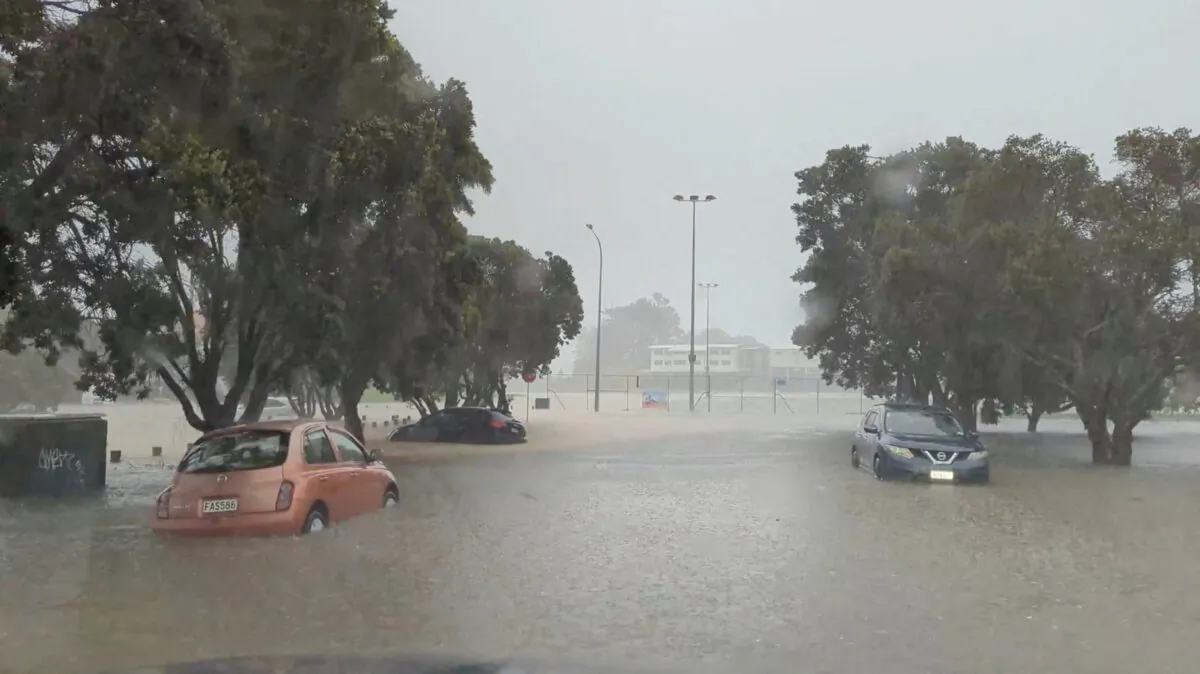 Cars in a flooded street during heavy rainfall in Auckland, New Zealand, on Jan. 27, 2023. (@MonteChristoNZ via Reuters)