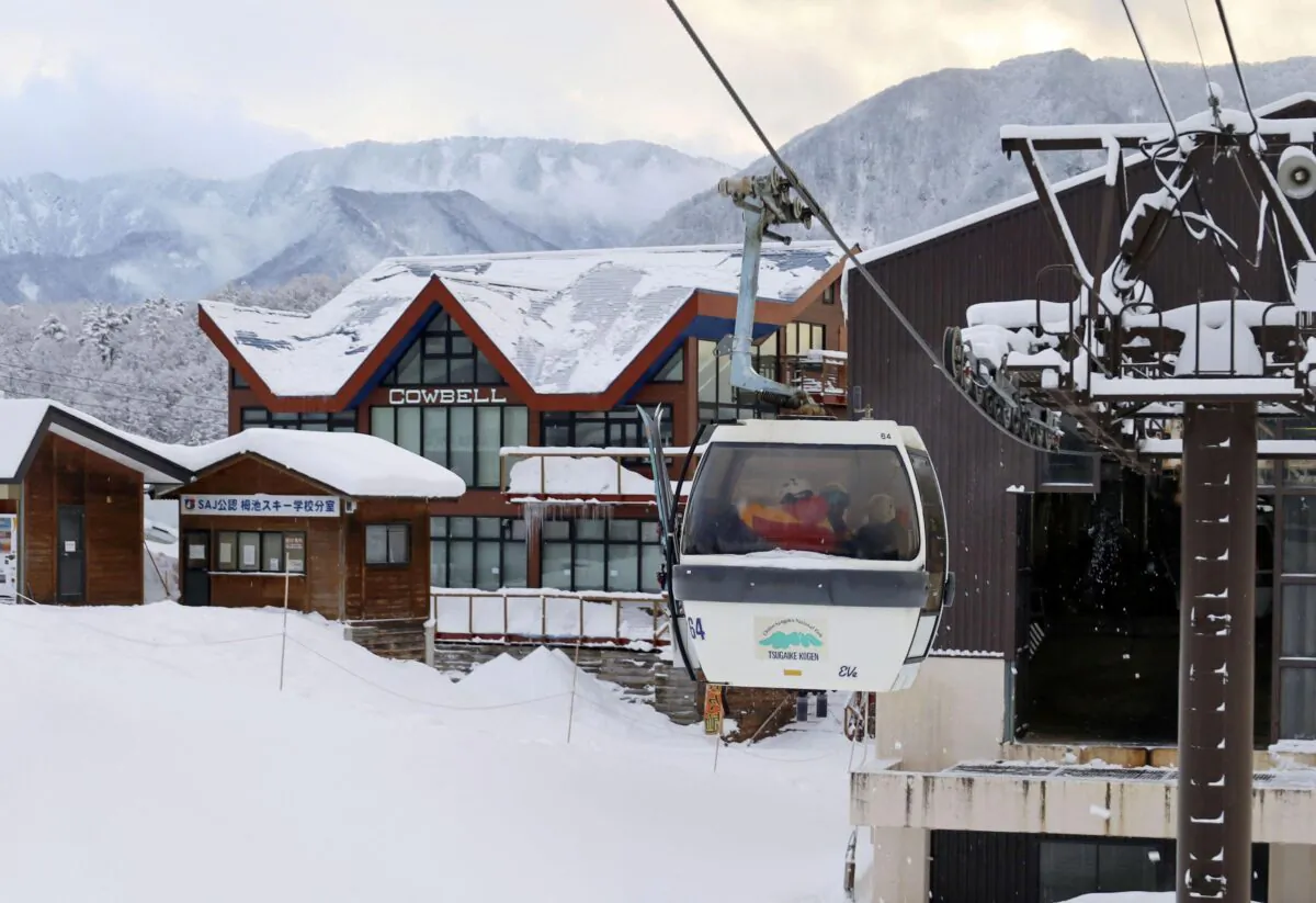 Rescue workers ride a gondola at a ski resort as they take part in a search for missing skiers following an avalanche the previous day, in the village of Otari in Nagano Prefecture, central Japan, on Jan. 30, 2023. (Kyodo via Reuters)