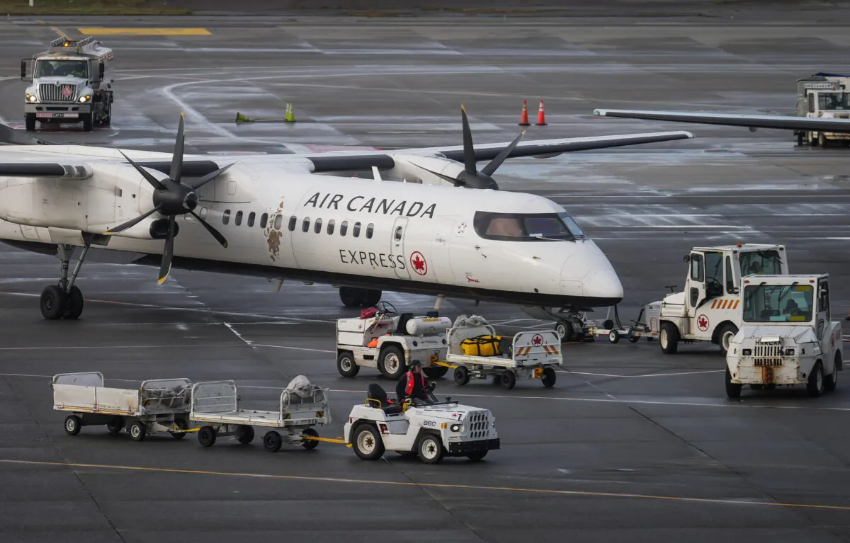 An Air Canada aircraft is parked at a gate at Vancouver International Airport in Richmond, B.C., on Dec. 26, 2022. (Darryl Dyck/The Canadian Press)