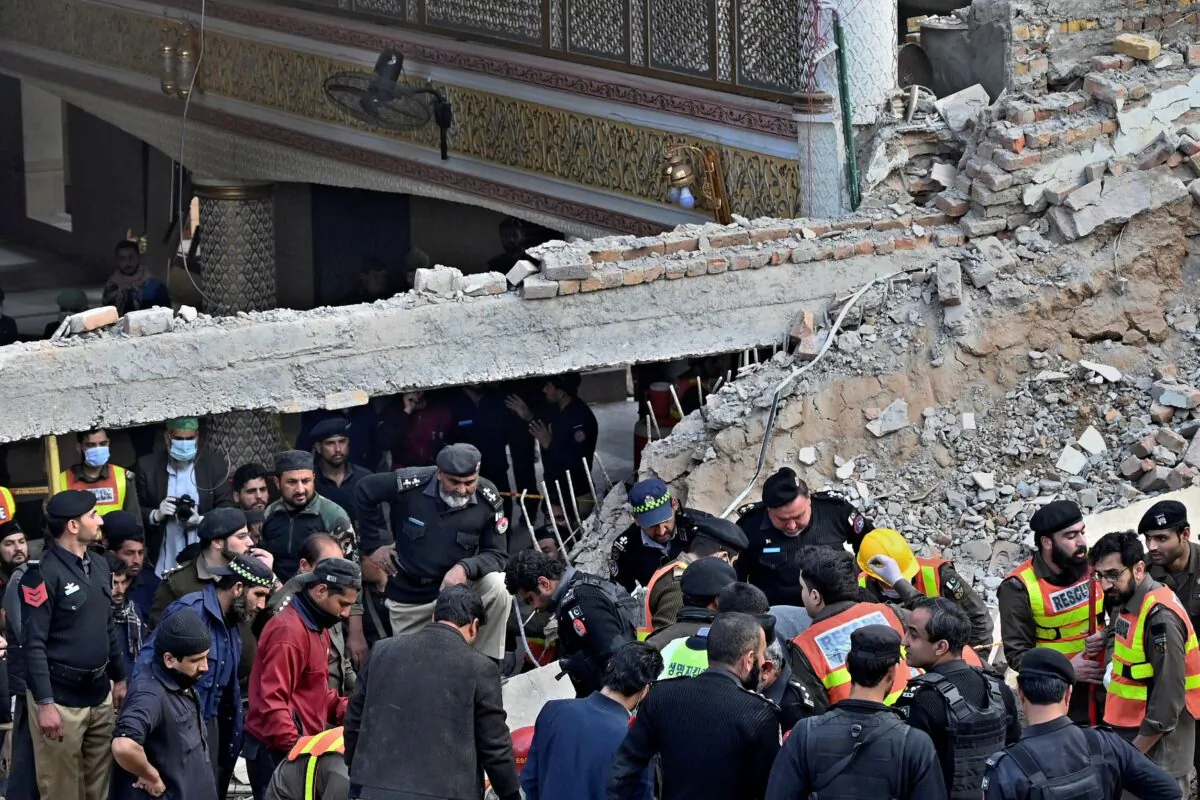 Security officials and rescue workers search for bodies at the site of suicide bombing in Peshawar, Pakistan, on Jan. 30, 2023. (Zubair Khan/AP Photo)