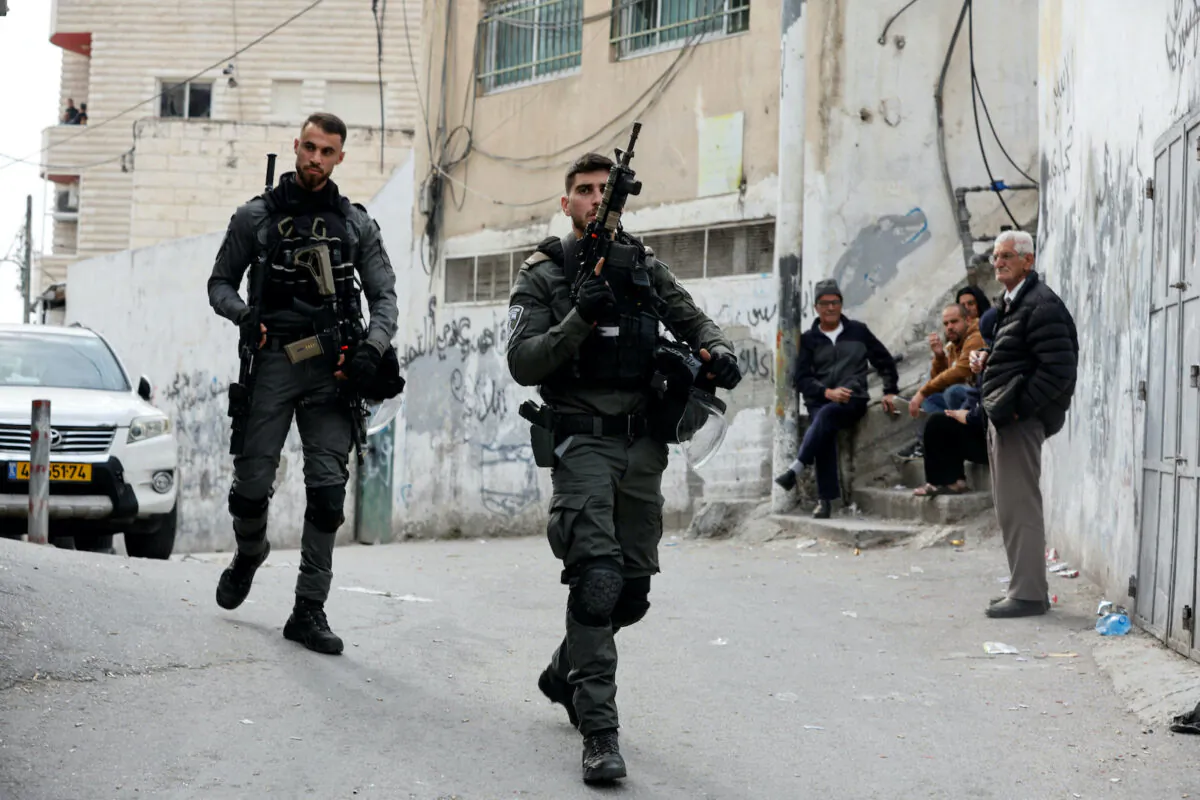 Israeli Border police officers walk outside the house of Palestinian gunman Khaire Alkam in A-Tur in East Jerusalem, after Alkam shot and killed seven people near a synagogue in Neve Yaacov, on Jan. 28, 2023. (Ammar Awad/Reuters)
