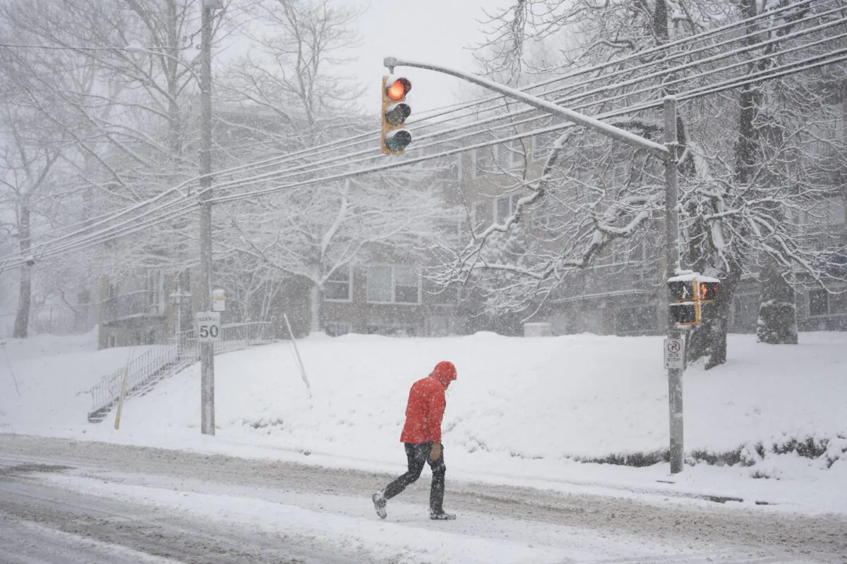 A pedestrian crosses a street in Halifax during a winter storm on Jan. 20, 2023. (The Canadian Press/Darren Calabrese)