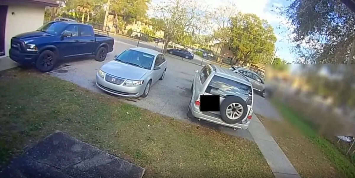 A tinted four-door sedan pulls up near an intersection in Lakeland where people were milling about, and people from inside the vehicle started shooting in all directions, in Lakeland, Fla., on Jan. 30, 2023, in a still from video. (Lakeland Police Department via AP/Screenshot via The Epoch Times)