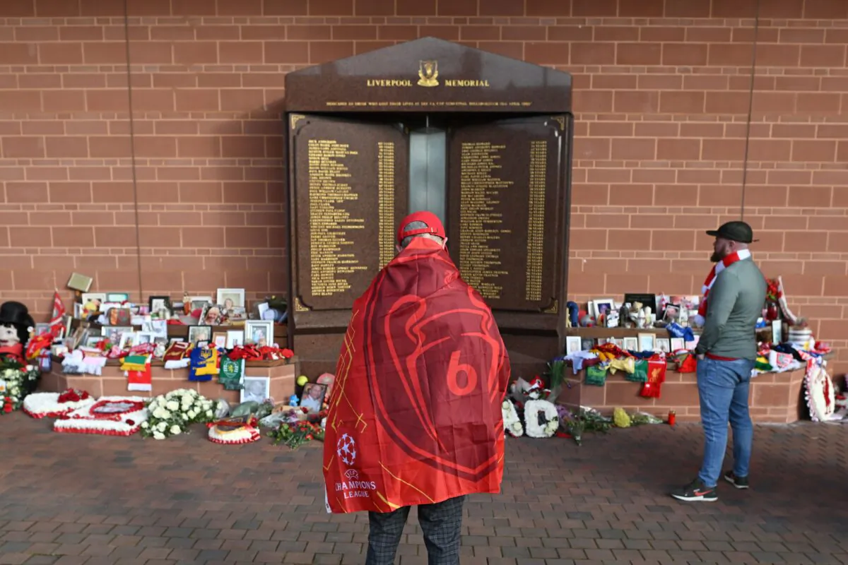 Liverpool supporters gather in front the eternal flame of the Hillsborough memorial as they arrive to attend the UEFA Champions League quarter final second leg football match between Liverpool and Benfica at the Anfield stadium, in Liverpool, United Kingdom, on April 13, 2022. (Paul Ellis/AFP via Getty Images)