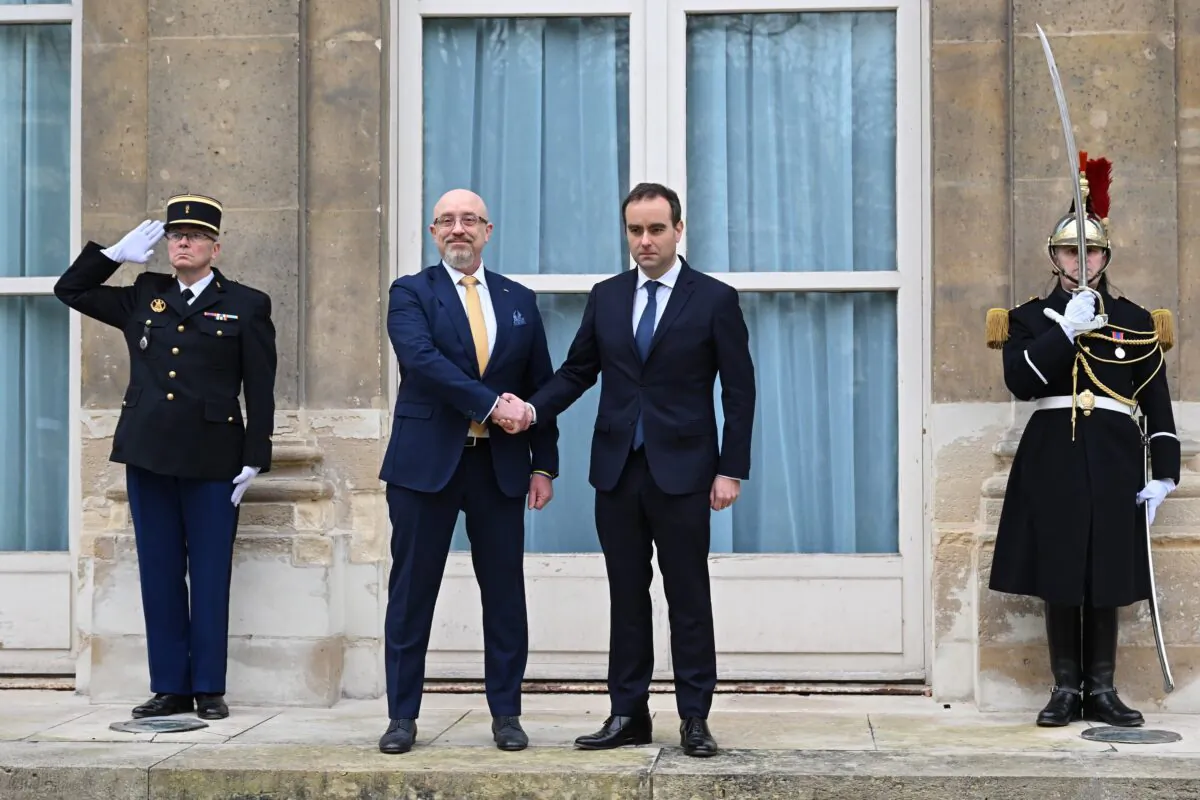 French Defense Minister Sebastien Lecornu (center R) and Ukrainian Minister of Defense Oleksii Reznikov pose during Reznikov's official visit at the French defense ministry in Paris on Jan. 31, 2023. (Julie Sebadelha, Pool via AP)