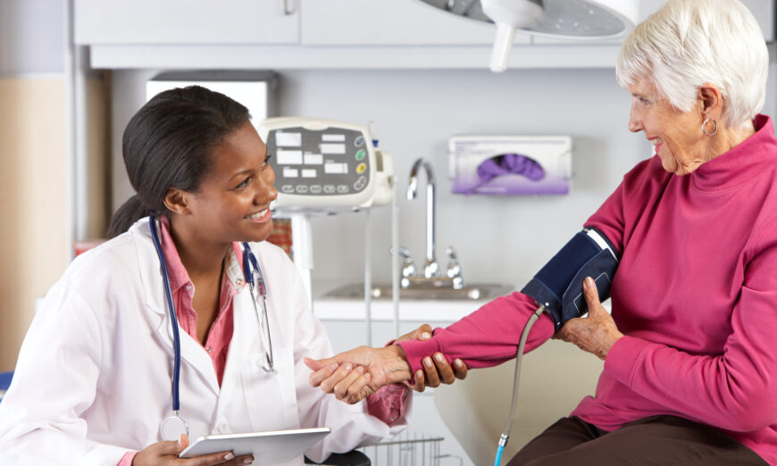 Doctor taking patient's blood pressure. (Shutterstock)