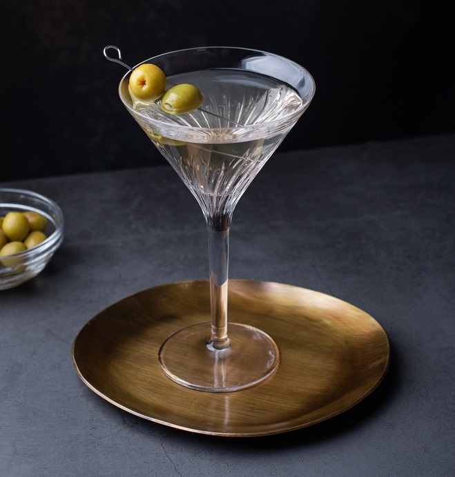 A classic dry martini calls for more gin than vermouth, possibly orange bitters, and an olive or lemon twist garnish. (Maria Shipakina/Shutterstock)