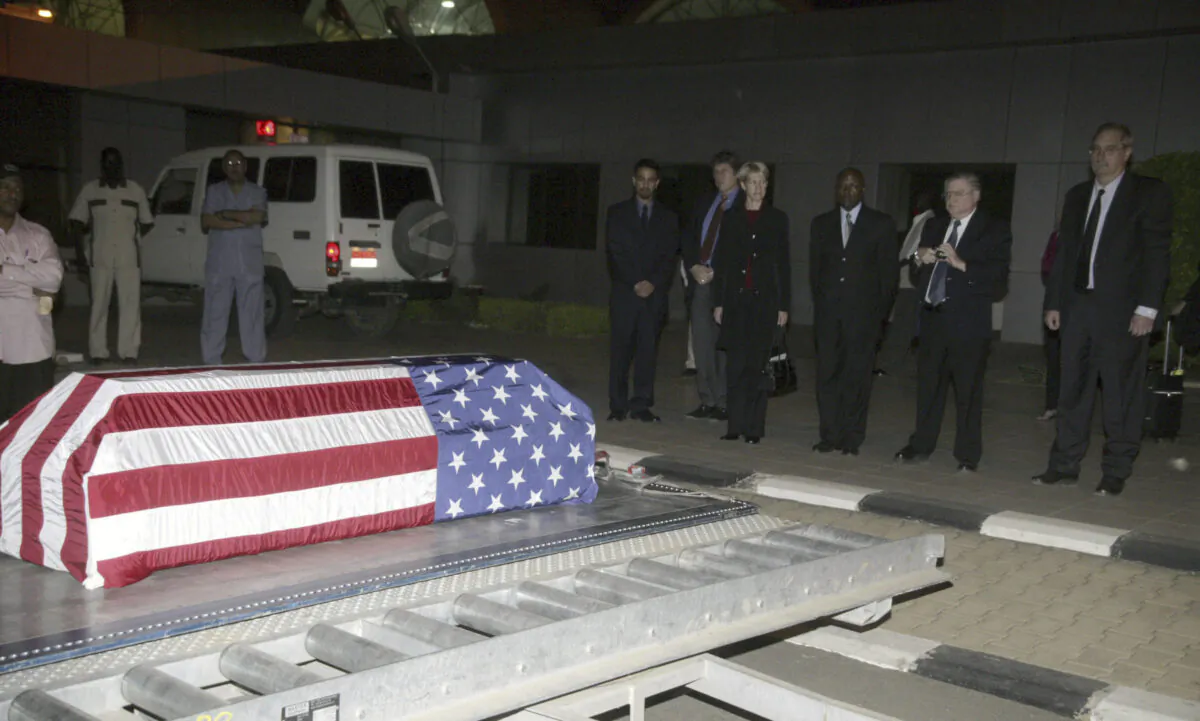 The flag-draped coffin of U.S. diplomat John Granville, 33, who worked for the U.S. Agency for International Development, is received by U.S. officials in Khartoum, Sudan, on Jan. 3, 2008. (Abd Raouf/AP Photo)