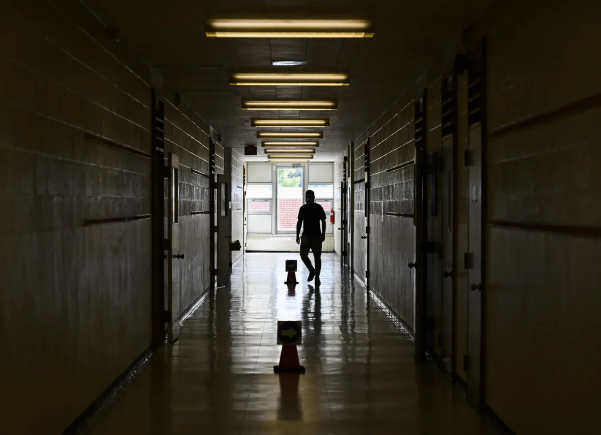 A teacher walks in the hallway of a junior public school in Ontario in a file photo. (The Canadian Press/Nathan Denette)