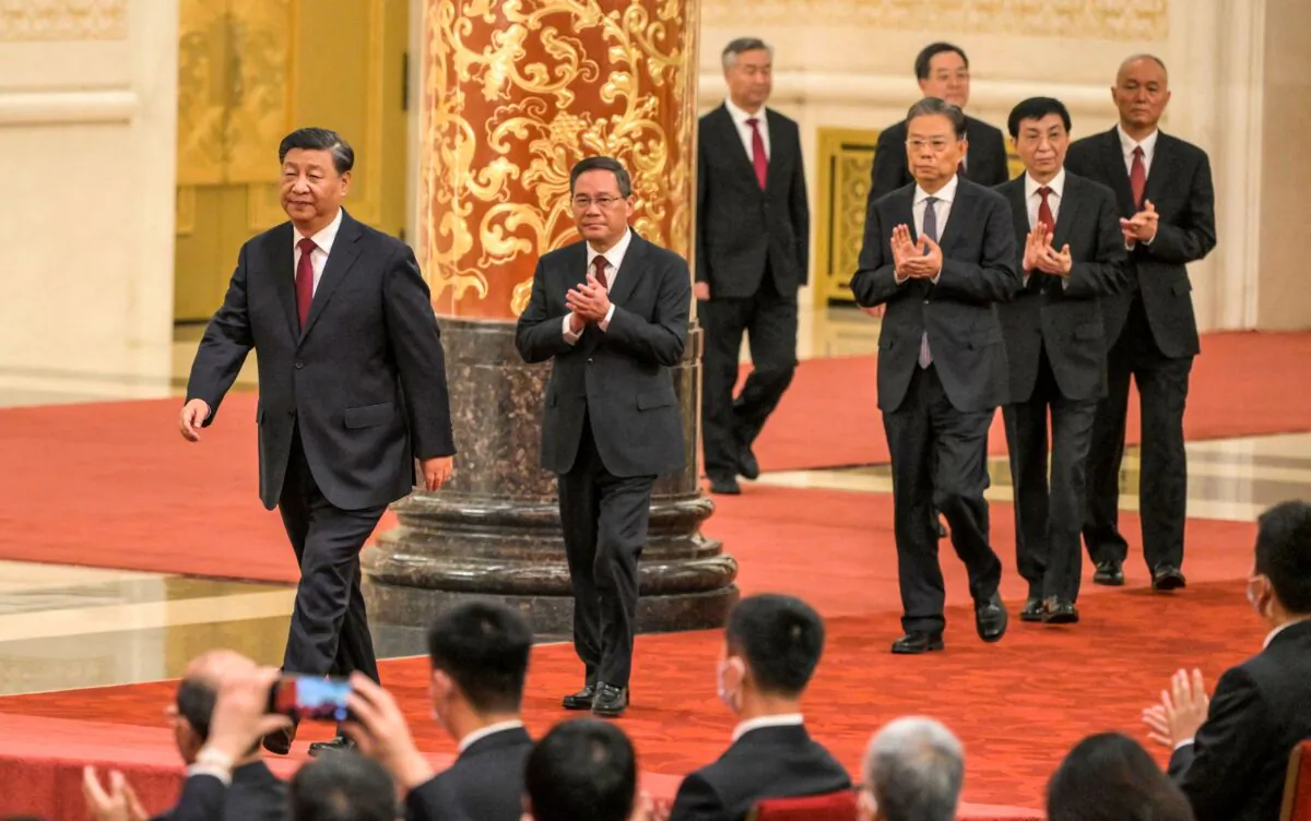 Chinese leader Xi Jinping (L) walks with (2nd L to R) Li Qiang, Li Xi, Zhao Leji, Ding Xuexiang, Wang Huning and Cai Qi, members of the Chinese Communist Party's new Politburo Standing Committee, China's top decision-making body, as they meet the media in the Great Hall of the People in Beijing on Oct. 23, 2022. (Wang Zhao/AFP via Getty Images)