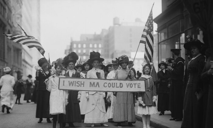 A group of Women's Suffrage activists march in a parade carrying a banner reading "I Wish Ma Could Vote" circa 1913. (FPG/Archive Photos/Getty Images)