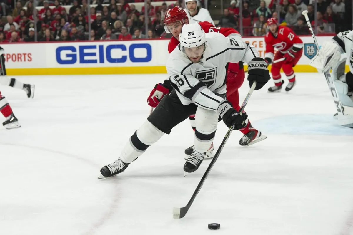 Los Angeles Kings defenseman Sean Walker (26) holds onto the puck against Carolina Hurricanes center Paul Stastny (26) during the first period at PNC Arena in Raleigh, N. C., on Jan. 31, 2023. (James Guillory/USA TODAY Sports via Field Level Media)
