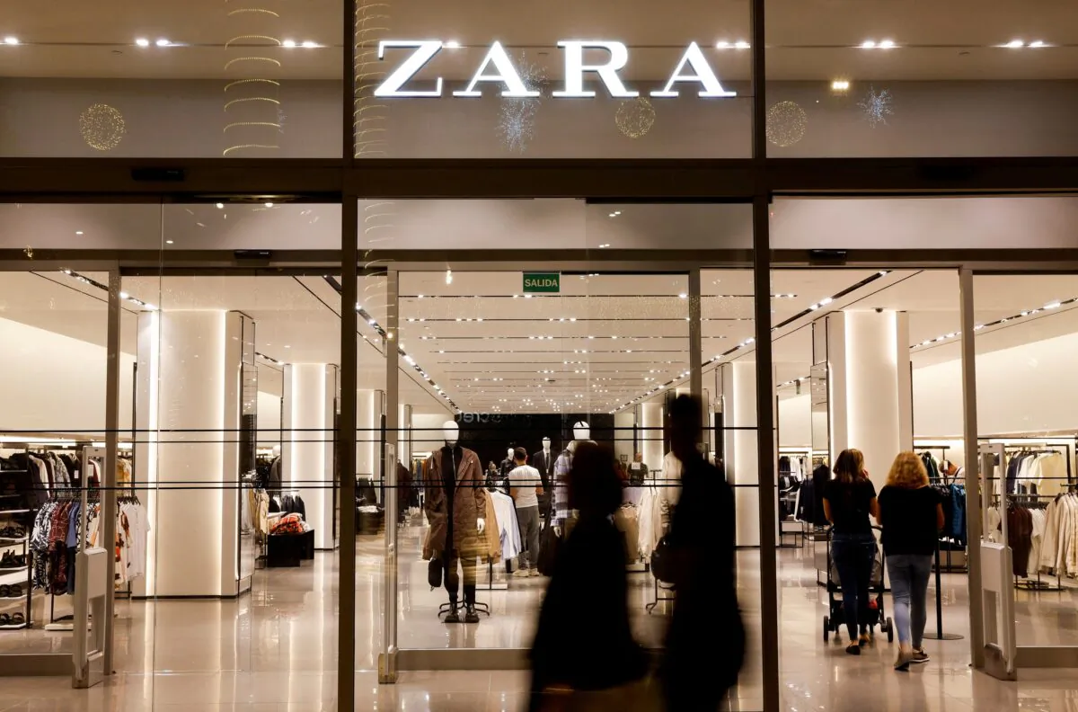 Shoppers walk past a Zara clothes store, part of the Spanish group Inditex, in Las Palmas de Gran Canaria, Spain, on Dec. 13, 2022. (Borja Suarez/Reuters)