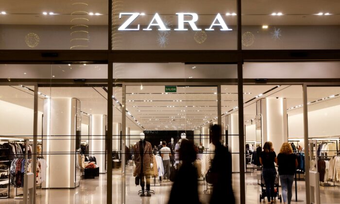 Shoppers walk past a Zara clothes store, part of the Spanish group Inditex, in Las Palmas de Gran Canaria, Spain, on Dec. 13, 2022. (Borja Suarez/Reuters)