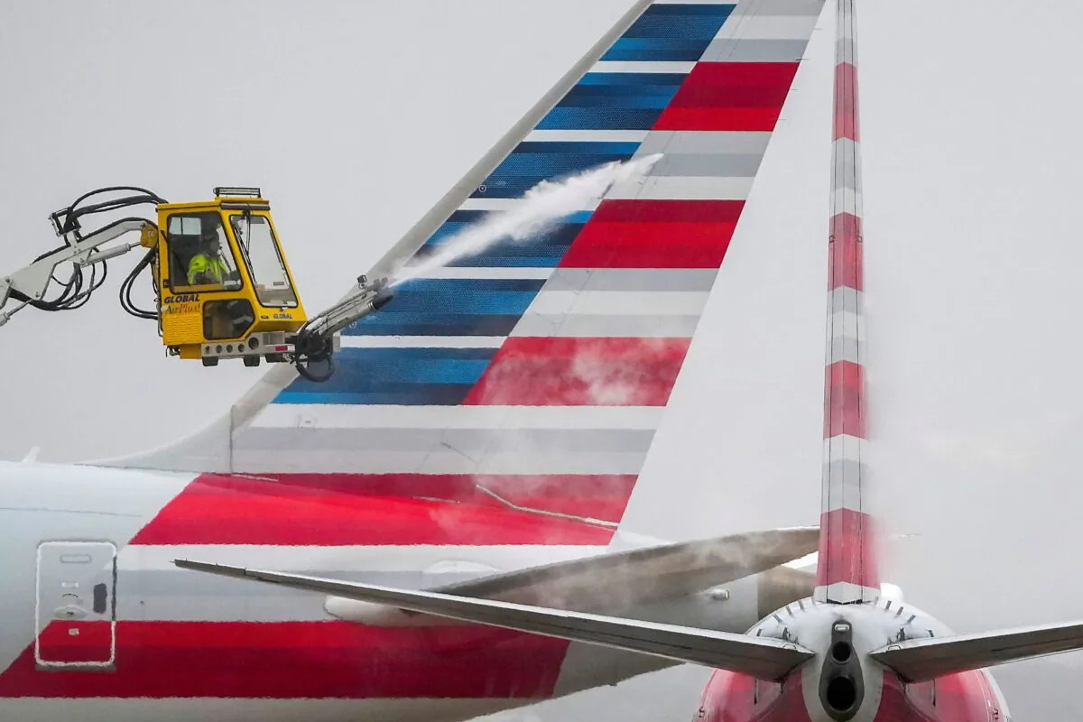 An American Airlines aircraft undergoes deicing procedures at Dallas/Fort Worth International Airport in Texas on Jan. 30, 2023. (Lola Gomez/The Dallas Morning News via AP)