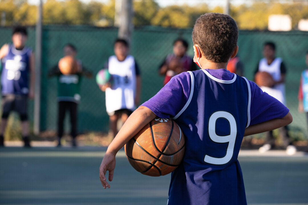 Children take part in a one hour basketball training session hosted by the YMCA of Orange County in Fullerton, Calif., on Feb. 1, 2023. (John Fredricks/The Epoch Times)