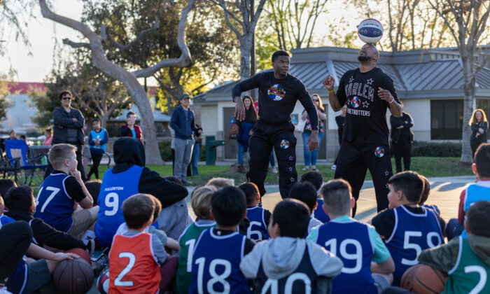 Children participate in a basketball training session with members of the Harlem Globetrotters, hosted by the YMCA of Orange County in Fullerton, Calif., on Feb. 1, 2023. (John Fredricks/The Epoch Times)